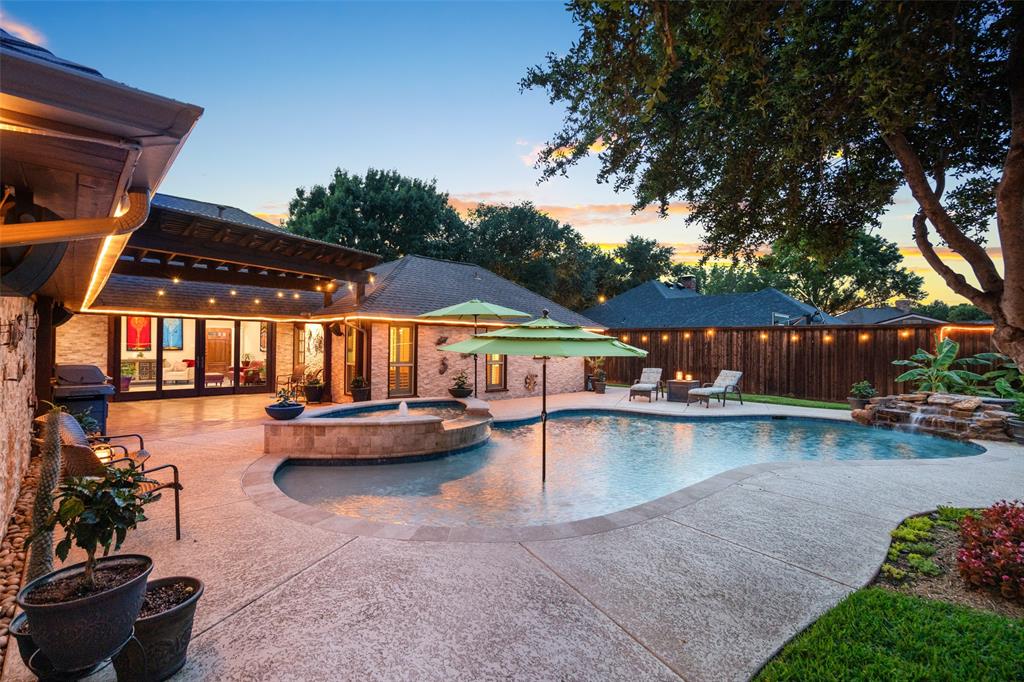 400 Hunters Ridge Circle Coppell, TX 75019 - Photo 32 of 35 a view of swimming pool with outdoor seating and a garden