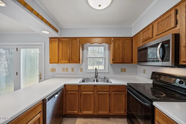 a view of a hallway with a chandelier fan and closet area