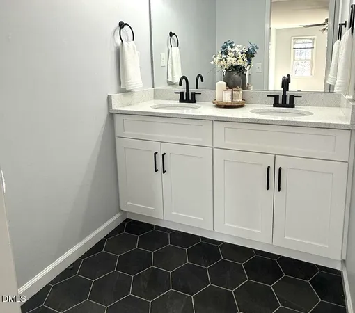 a bathroom with a sink vanity and a mirror