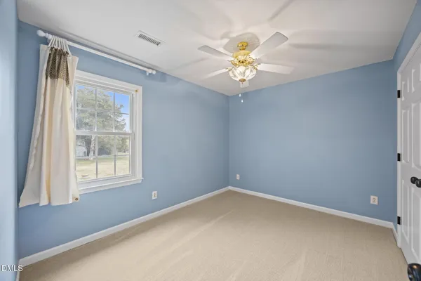 a view of a livingroom with a chandelier fan