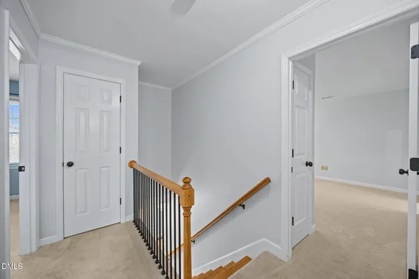 a view of a room with a ceiling fan and window