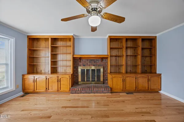 a living room with furniture a fireplace and a large window