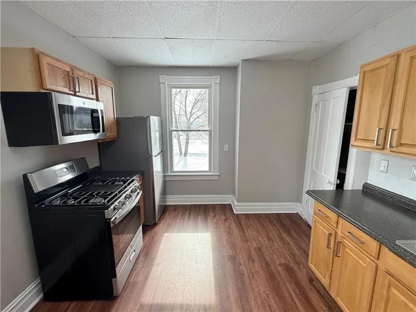 a kitchen with granite countertop a stove and a sink