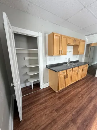 a kitchen with wooden floors and a window