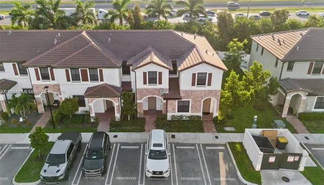 an aerial view of a house with garden space and street view