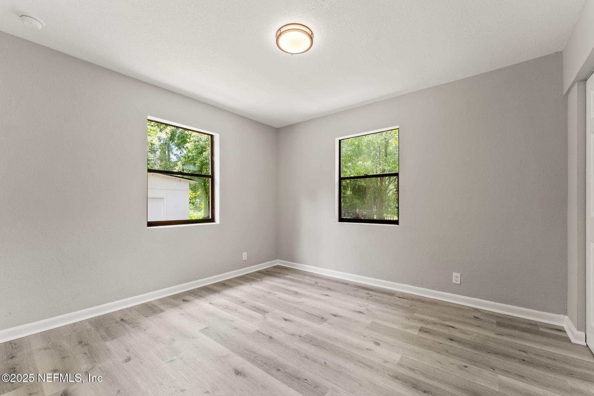 4924 Vermont Road Jacksonville, FL 32209 - Photo 12 of 19 an empty room with wooden floor and window