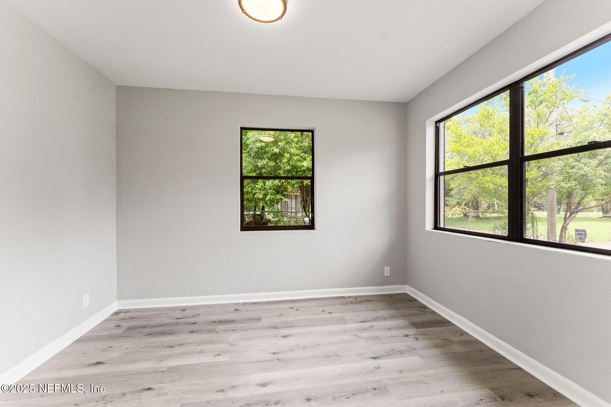 4924 Vermont Road Jacksonville, FL 32209 - Photo 14 of 19 an empty room with wooden floor and windows
