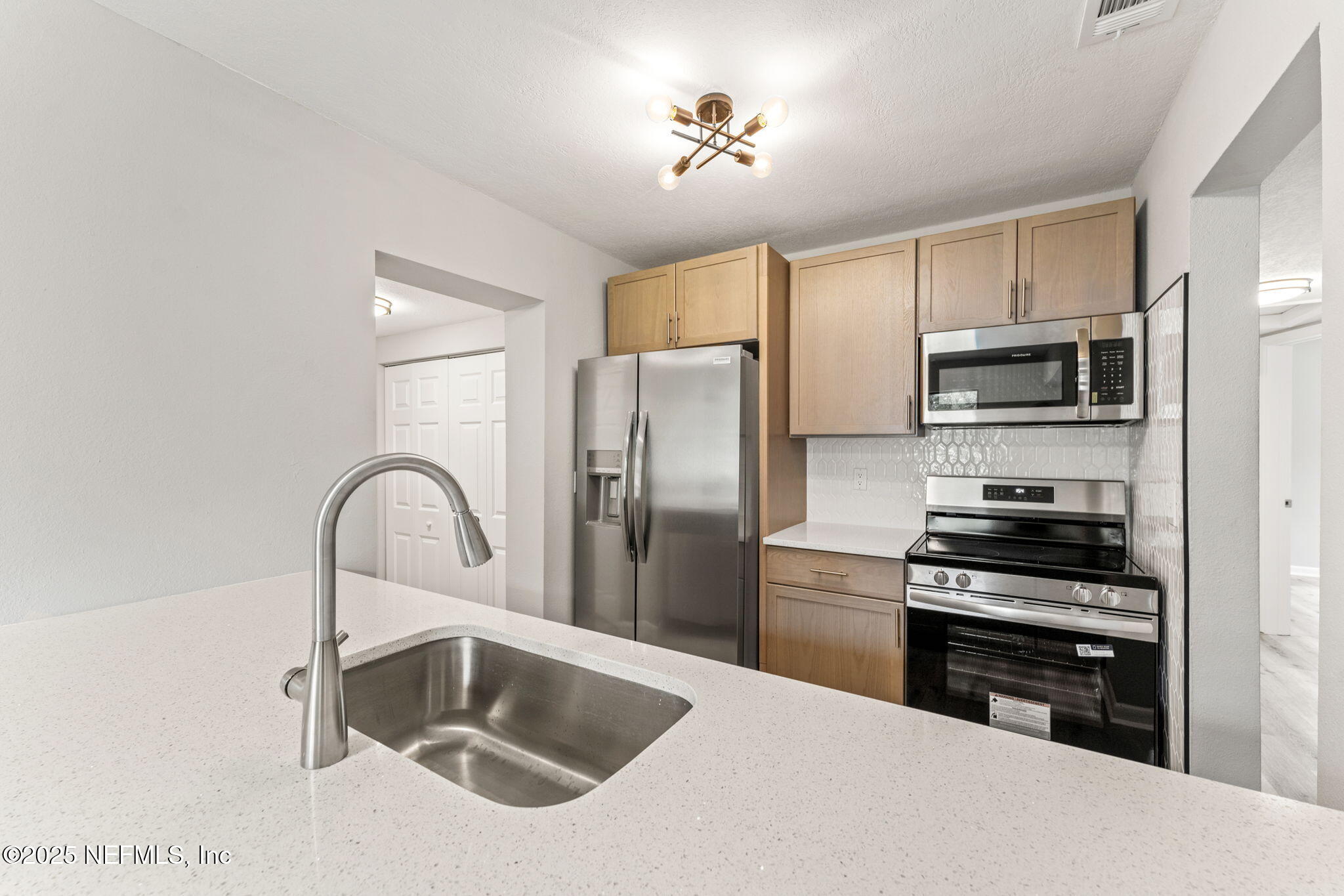 4924 Vermont Road Jacksonville, FL 32209 - Photo 3 of 19 a kitchen with a refrigerator stove and a sink