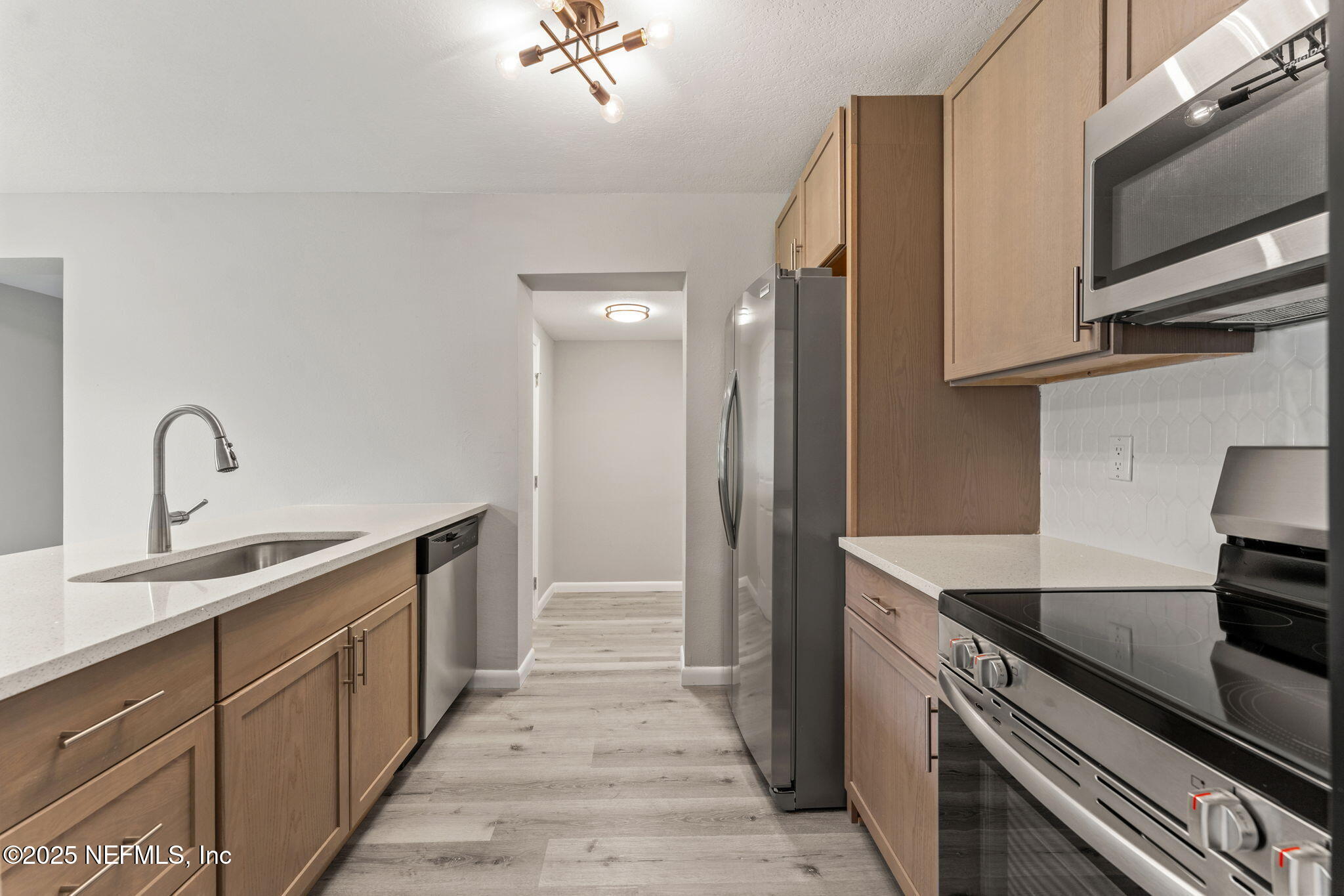 4924 Vermont Road Jacksonville, FL 32209 - Photo 4 of 19 a kitchen with a sink and stainless steel appliances