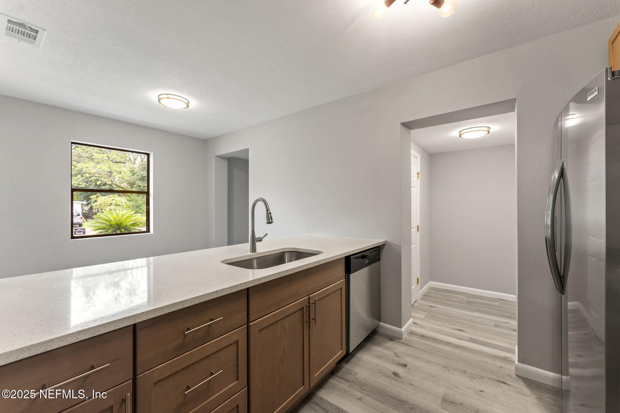 4924 Vermont Road Jacksonville, FL 32209 - Photo 5 of 19 a kitchen with stainless steel appliances granite countertop a sink and a refrigerator