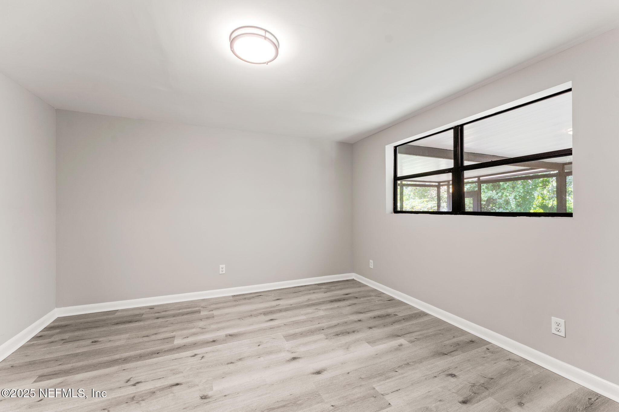 4924 Vermont Road Jacksonville, FL 32209 - Photo 8 of 19 a view of empty room with wooden floor and fan