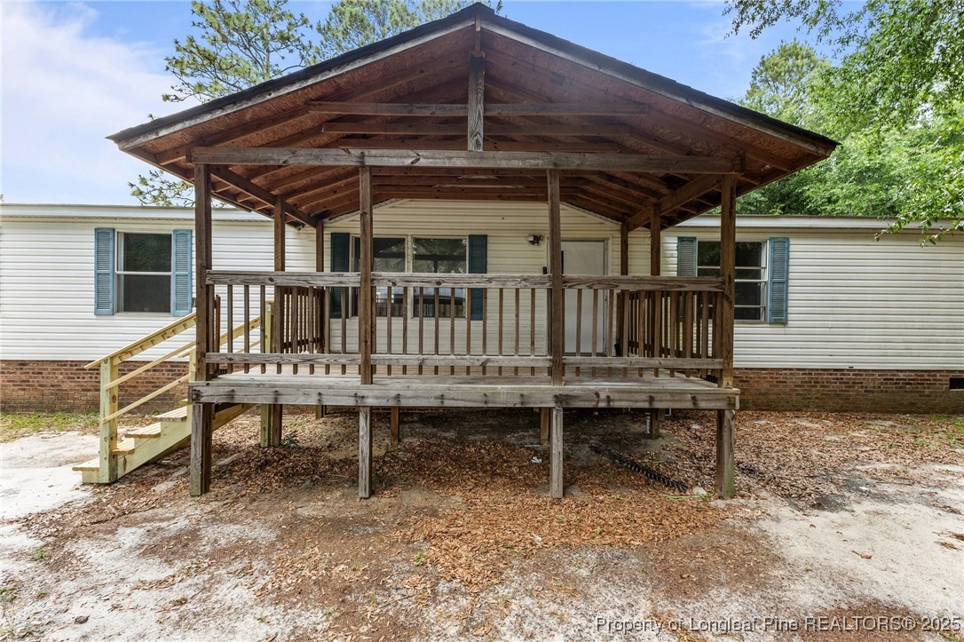 a view of a deck that has a table and chairs