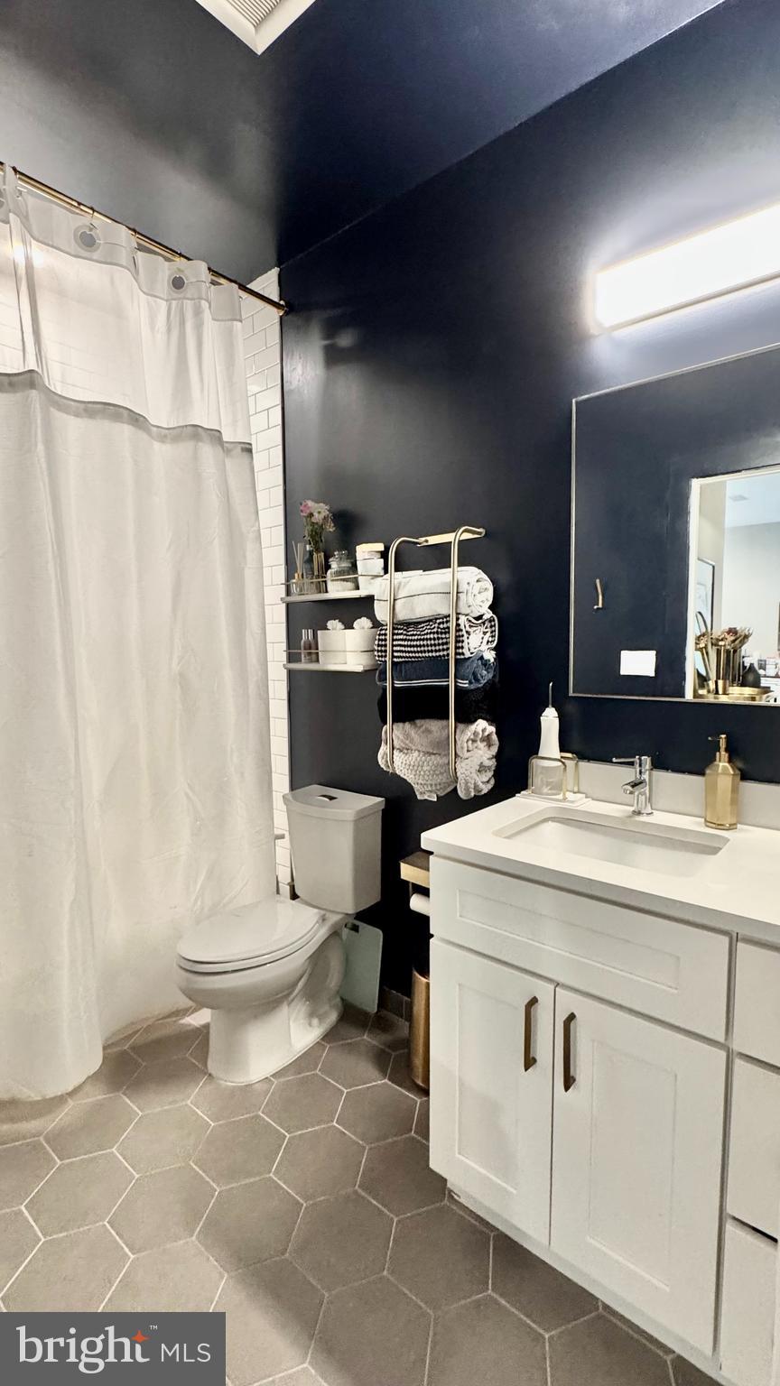 1016 17th Place Northeast, Unit 301 Washington, DC 20002 - Photo 11 of 12 a bathroom with a sink and mirror