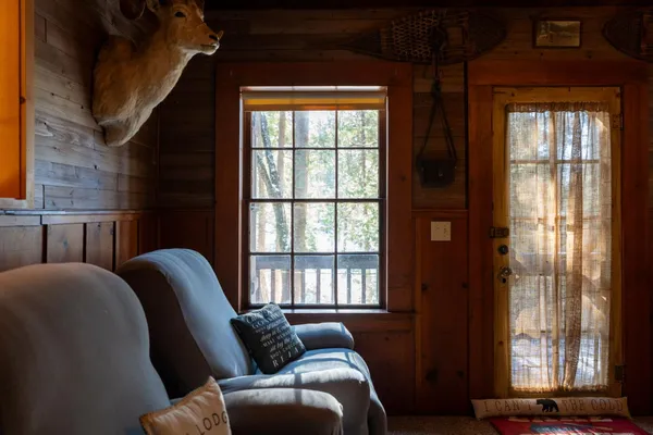 a living room with furniture and large windows