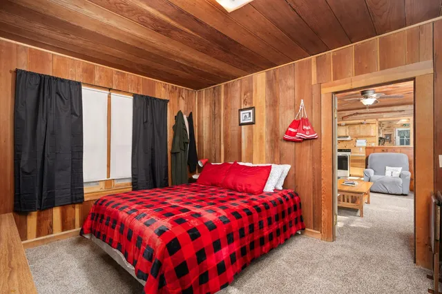 a bed sitting in a bedroom next to a window