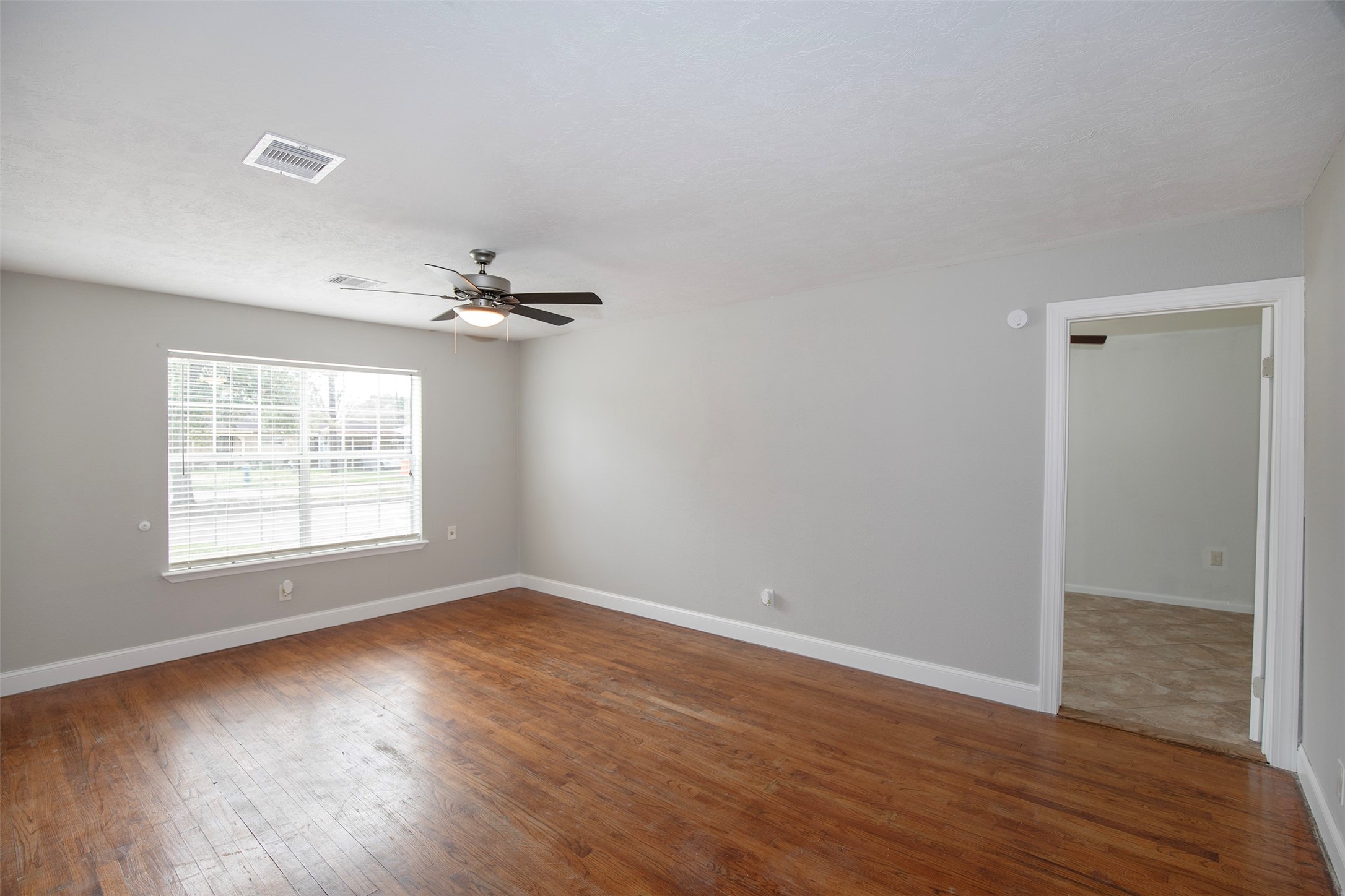 5535 Allendale Road Houston, TX 77017 - Photo 5 of 29 wooden floor in an empty room with a window