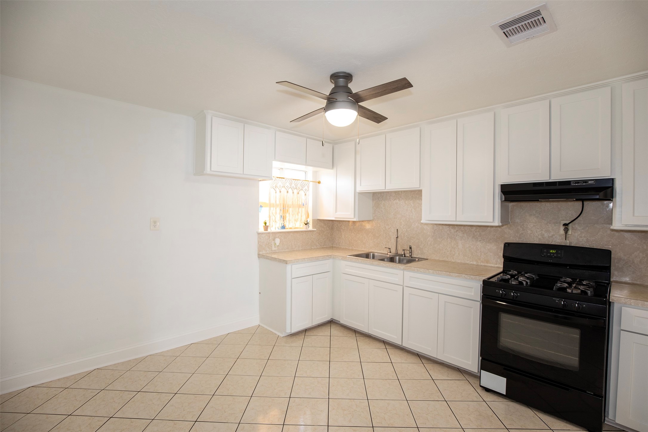 5535 Allendale Road Houston, TX 77017 - Photo 9 of 29 a kitchen with a sink window and cabinets