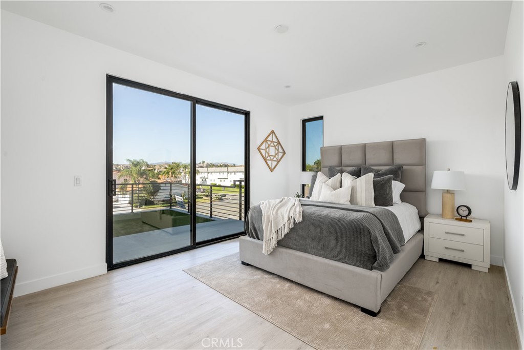 28896 Vacation Drive Canyon Lake, CA 92587 - Photo 13 of 39 a spacious bedroom with a bed and large window