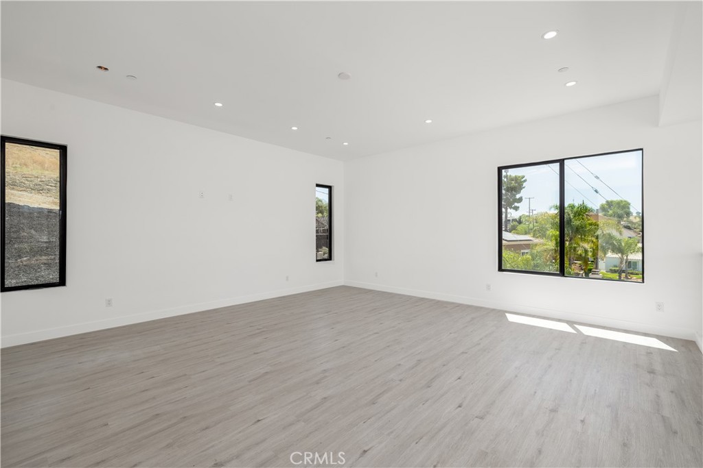 28896 Vacation Drive Canyon Lake, CA 92587 - Photo 17 of 39 an empty room with wooden floor and windows