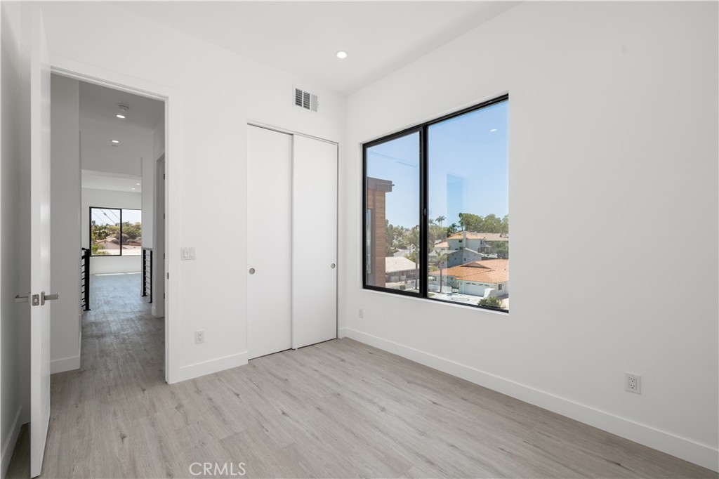 28896 Vacation Drive Canyon Lake, CA 92587 - Photo 23 of 39 wooden floor in an empty room with a window