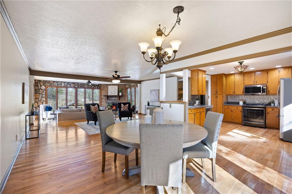 8277 Buchanan Highway Dallas, GA 30157 - Photo 22 of 36 a view of a dining room and livingroom with furniture wooden floor a chandelier