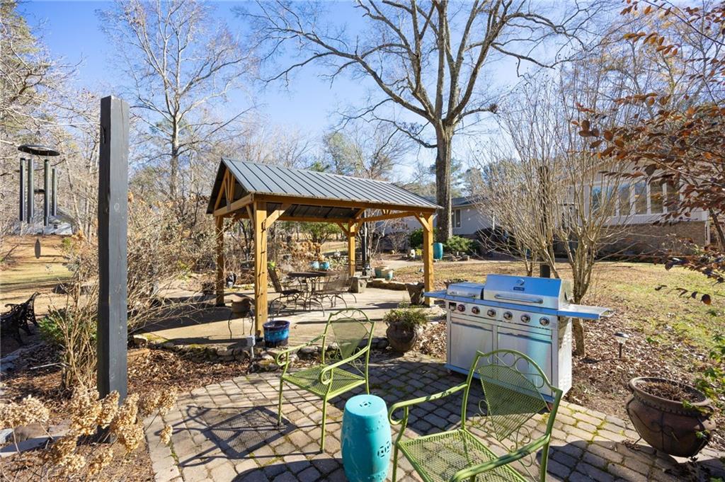 8277 Buchanan Highway Dallas, GA 30157 - Photo 34 of 36 a view of a patio with table and chairs under an umbrella