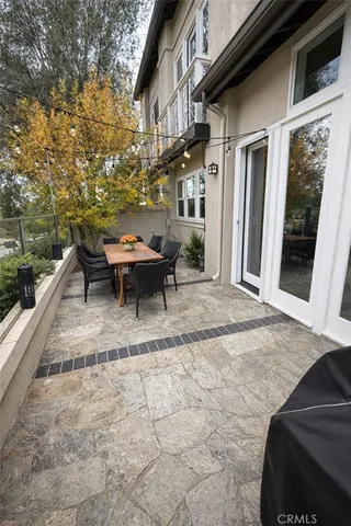 a backyard of a house with table and chairs