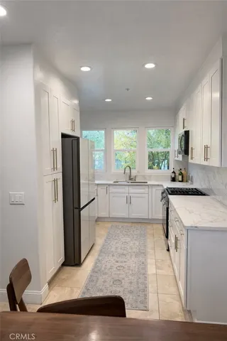 a kitchen with a refrigerator and a sink