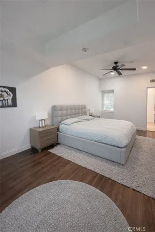 a bedroom with a bed and a night stand