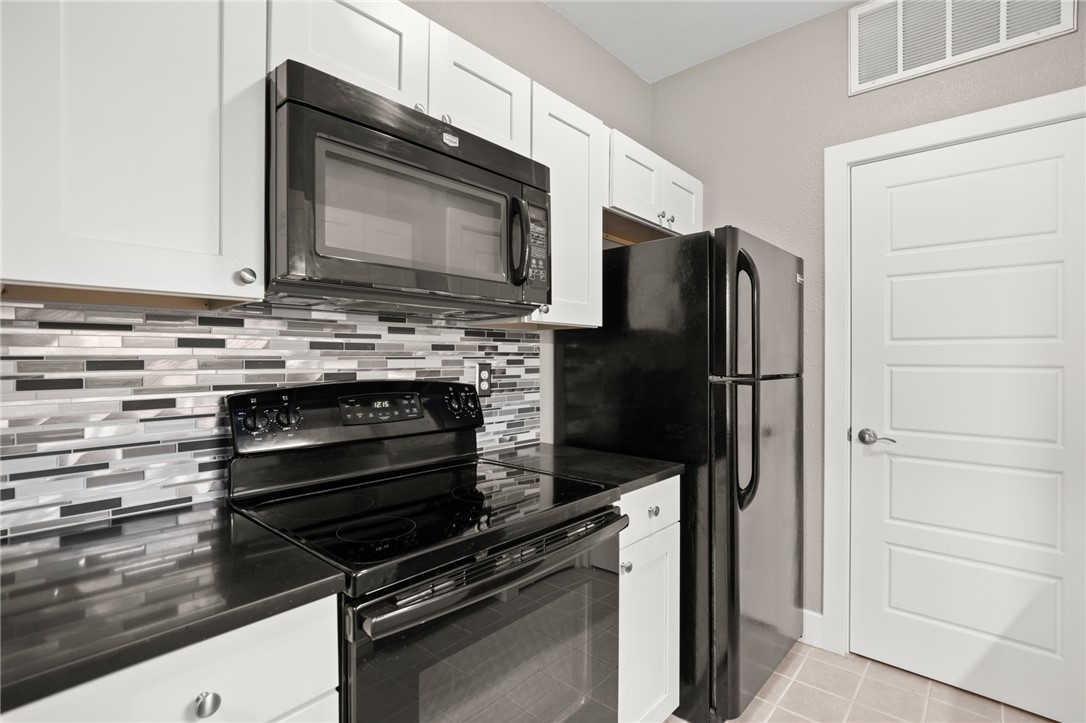 a kitchen with a refrigerator stove and microwave