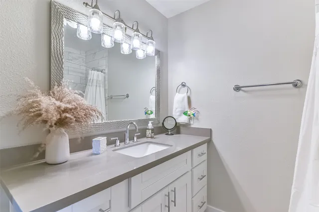 a bathroom with a sink a vanity and a mirror