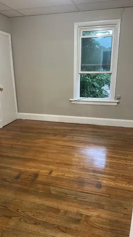 a view of room with wooden floor and window