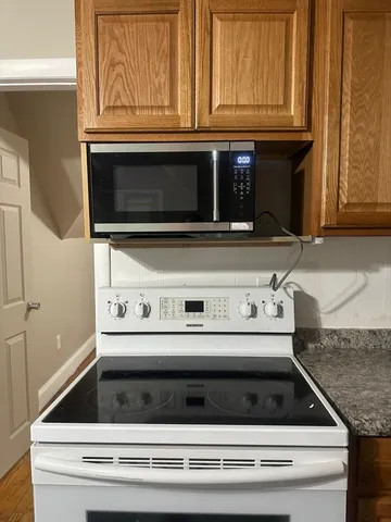 a stove top oven sitting inside of a kitchen