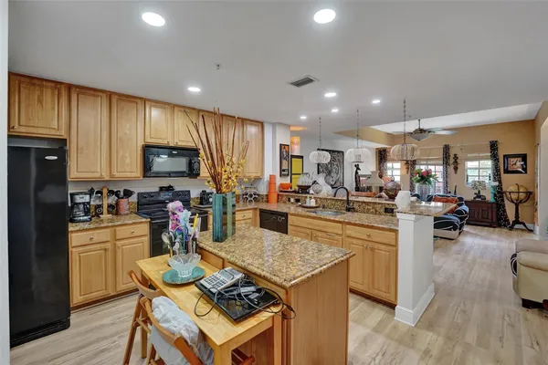 a kitchen with a sink dishwasher stove top oven and refrigerator