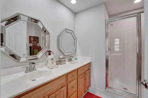 a bathroom with a double vanity sink and a mirror