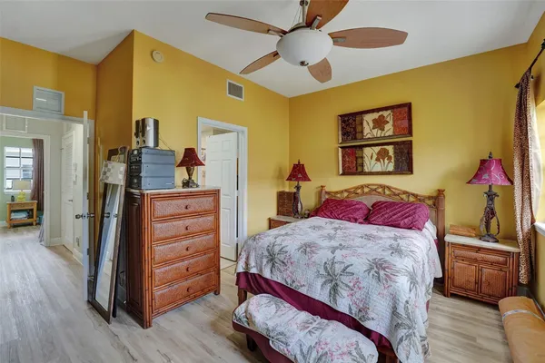 a bedroom with a bed and wooden floor