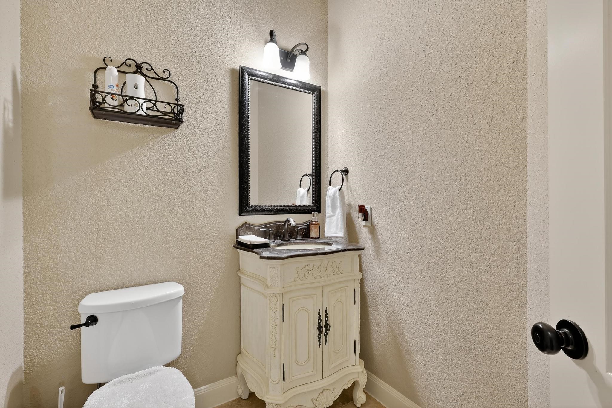 25803 Heritage Maple Drive Spring, TX 77389 - Photo 11 of 46 a bathroom with a toilet a sink and mirror