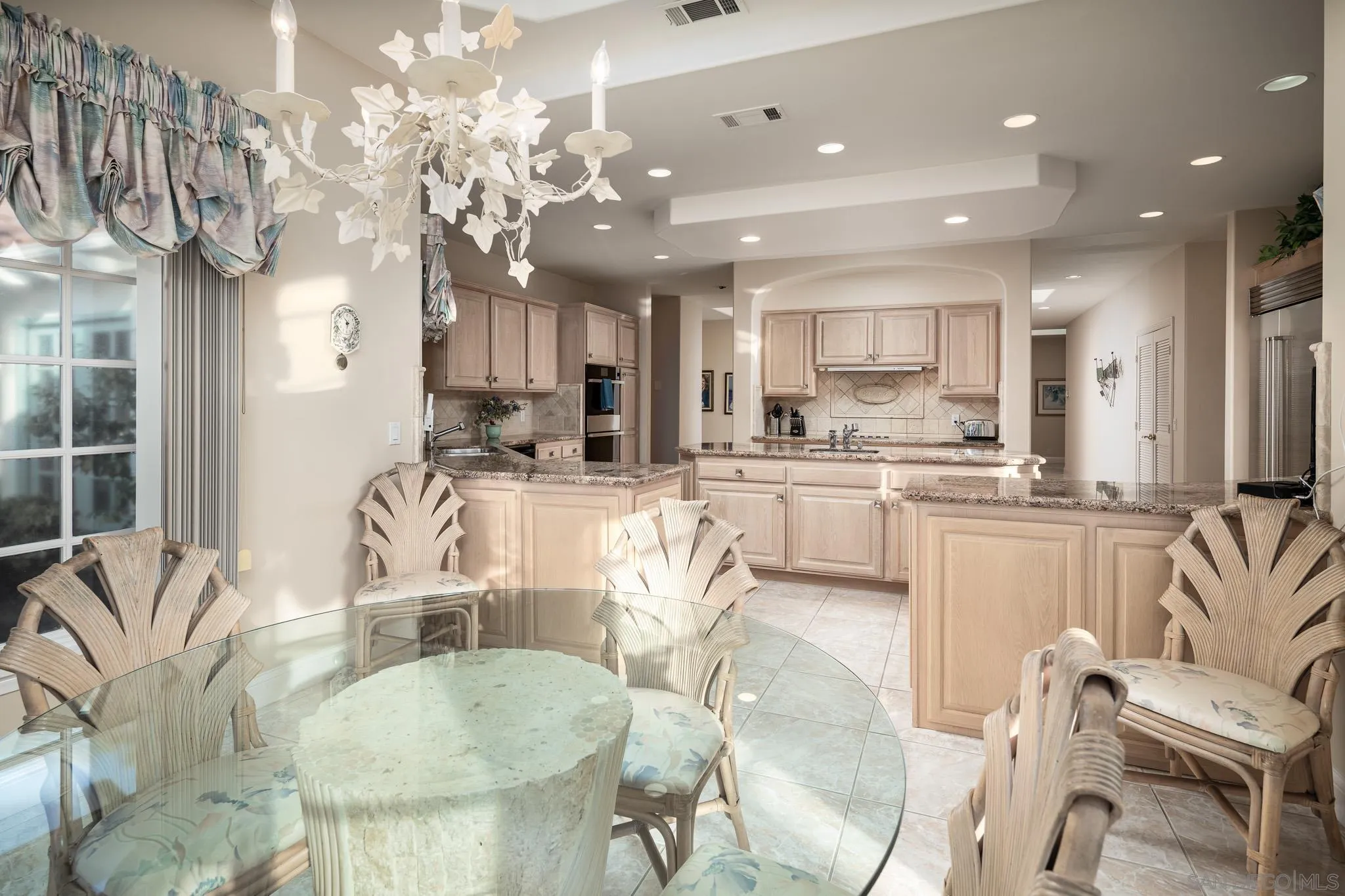 18221 Via Ascenso Rancho Santa Fe, CA 92067 - Photo 13 of 37 a kitchen with stainless steel appliances kitchen island granite countertop a sink and cabinets