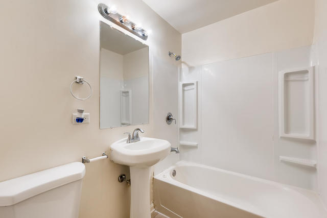 1923 Cherokee Road Carpentersville, IL 60110 - Photo 11 of 17 a bathroom with a sink a mirror toilet and bathtub