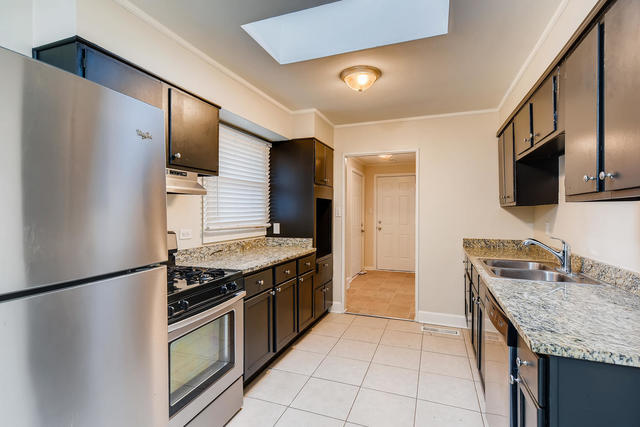 1923 Cherokee Road Carpentersville, IL 60110 - Photo 5 of 17 a kitchen with stainless steel appliances granite countertop a stove a refrigerator and a sink