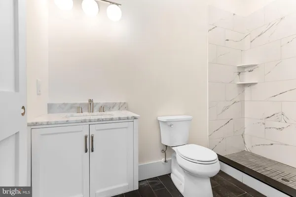 a white toilet sitting next to a bathroom sink