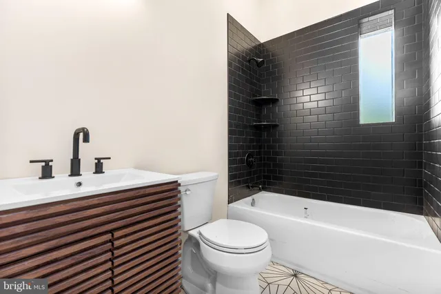 a bathroom with a sink a toilet and bathtub