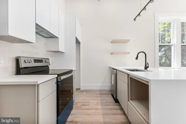 a kitchen with a stove and a sink