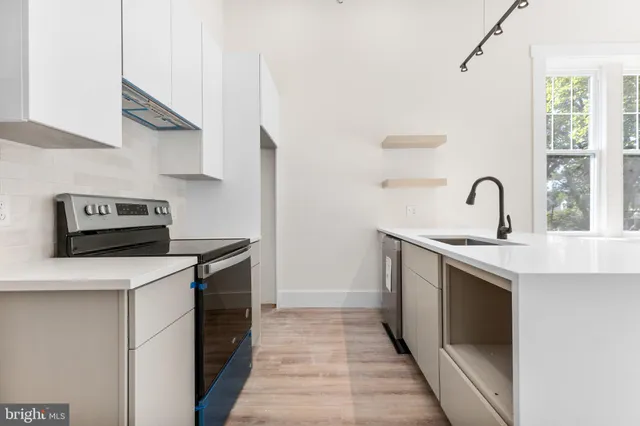 a kitchen with a stove and a sink