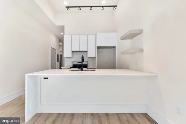 a view of kitchen with cabinets