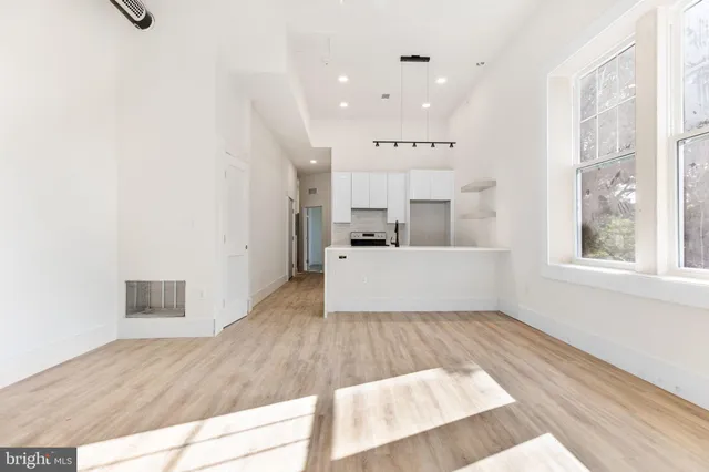 a living room with kitchen island furniture and a wooden floor