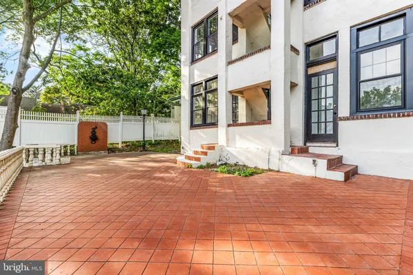a view of a white house with a outdoor space