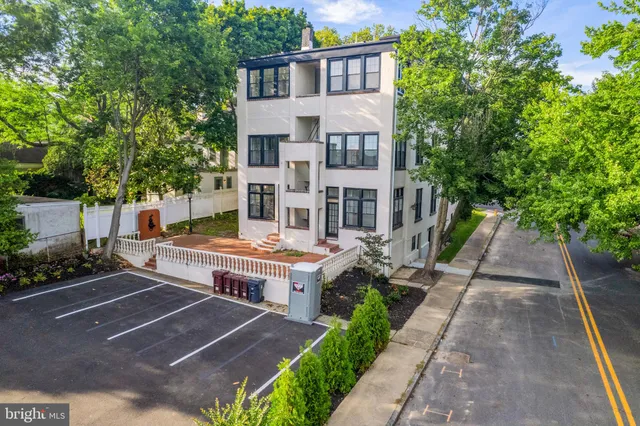a view of a patio with couches table and chairs and potted plants