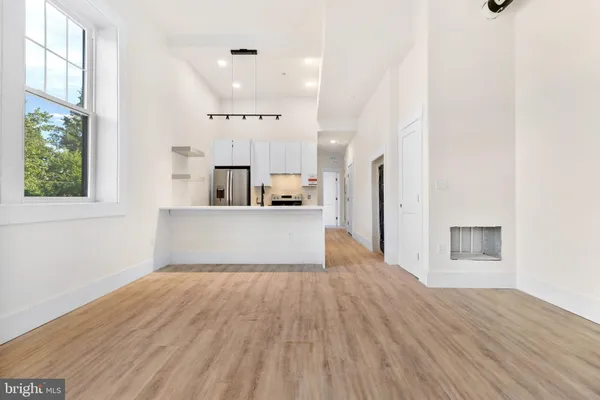 a view of a kitchen with furniture and wooden floor