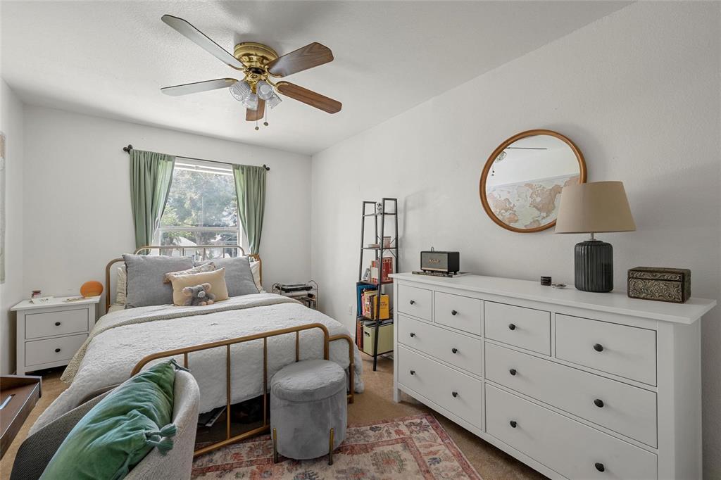 1915 South 7th Street Waco, TX 76706 - Photo 13 of 40 a bedroom with bed and a chandelier